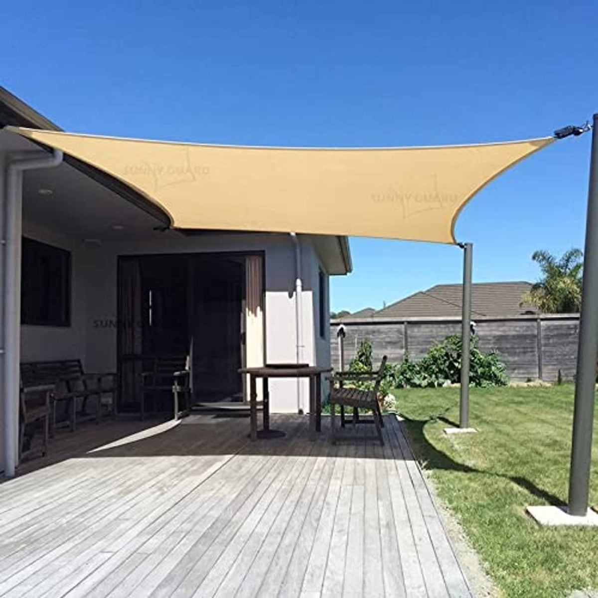 Sand UV shade sail rectangular canopy on metal poles over patio seating area