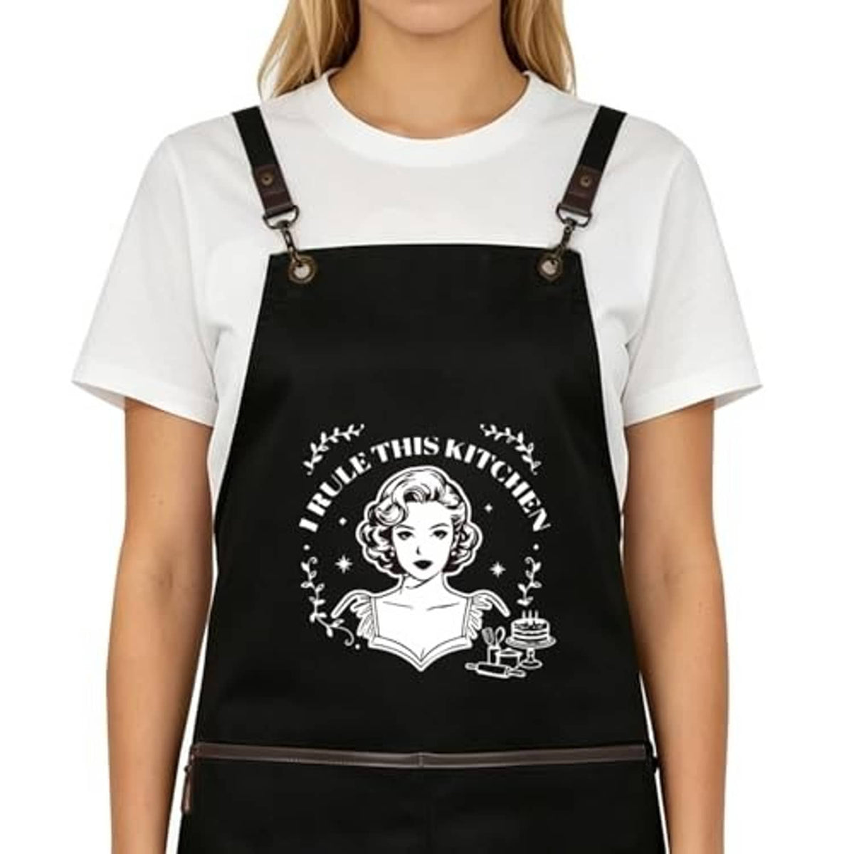 Black kitchen apron with centered cartoon chef graphic and adjustable shoulder straps
