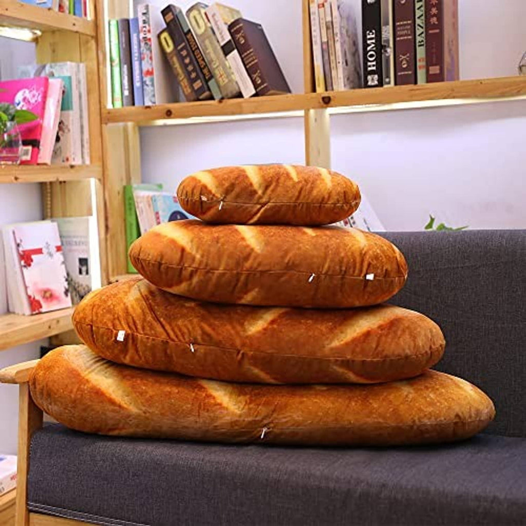 Stack of loaf-shaped plush bread pillows in brown-orange with cream stripes