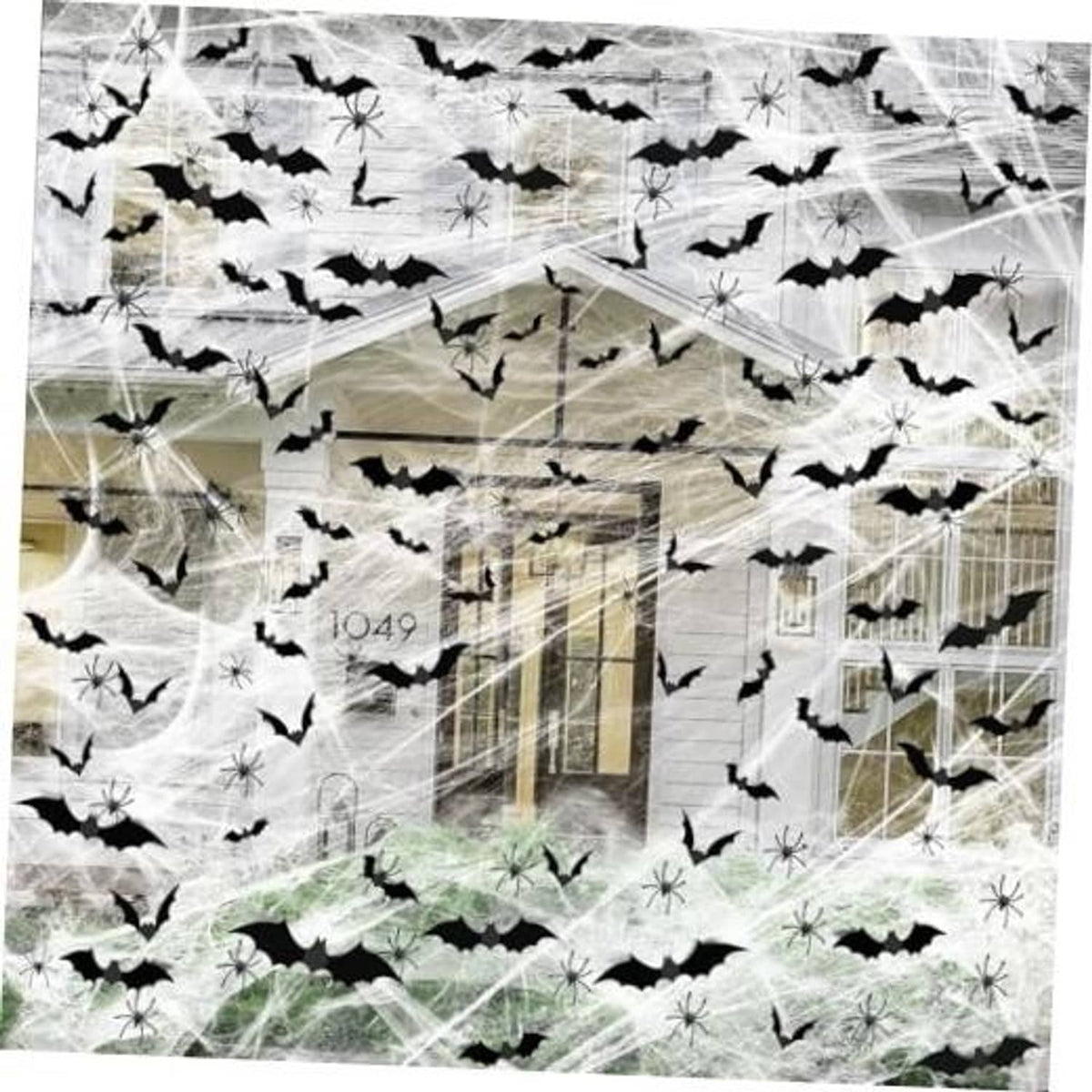Halloween spider web decoration with black bat decals spread over a house facade
