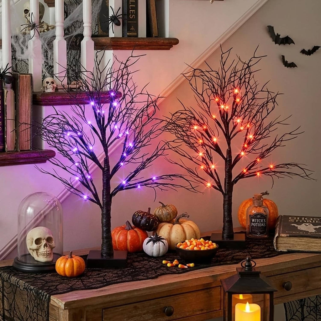 Halloween light trees with purple and orange LED branches on entryway console