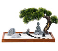 Mini zen garden kit on wooden tray with Buddha statue, rocks, sand, and stones