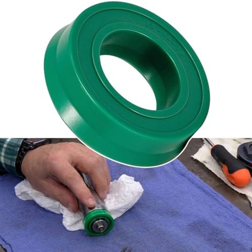 Hydraulic floor jack U-cup seal replacement being fitted, green seal held over bedding