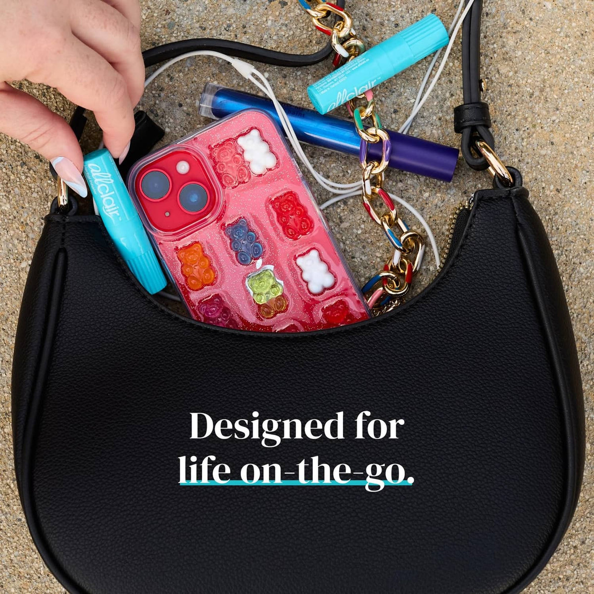 Turquoise herbal inhaler stick clipped in an open bag pocket near a phone case