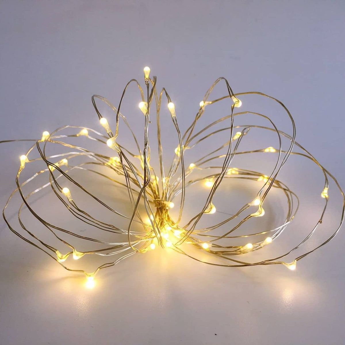 Mini starry string lights with warm LED bulbs on thin silver wire