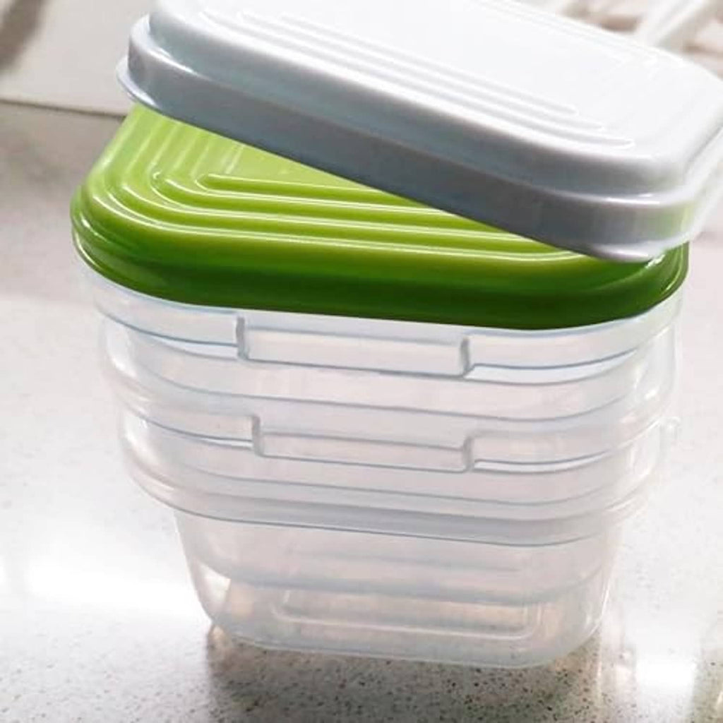 Close-up of baby food container with green lid and clear interlocking sides