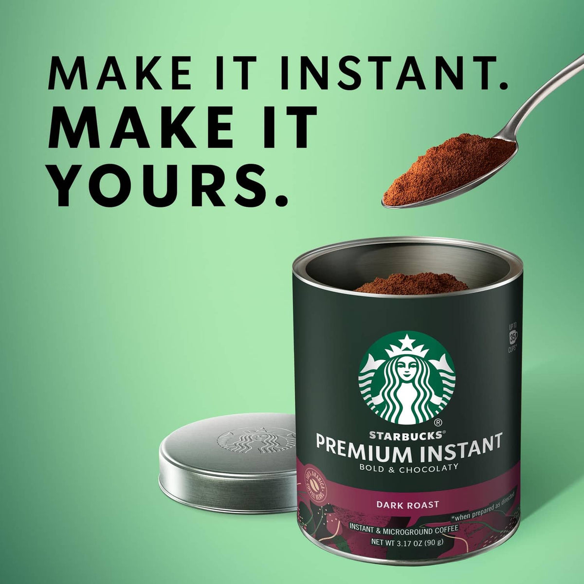 Starbucks Premium Instant Coffee dark roast can with spoon holding coffee grounds.