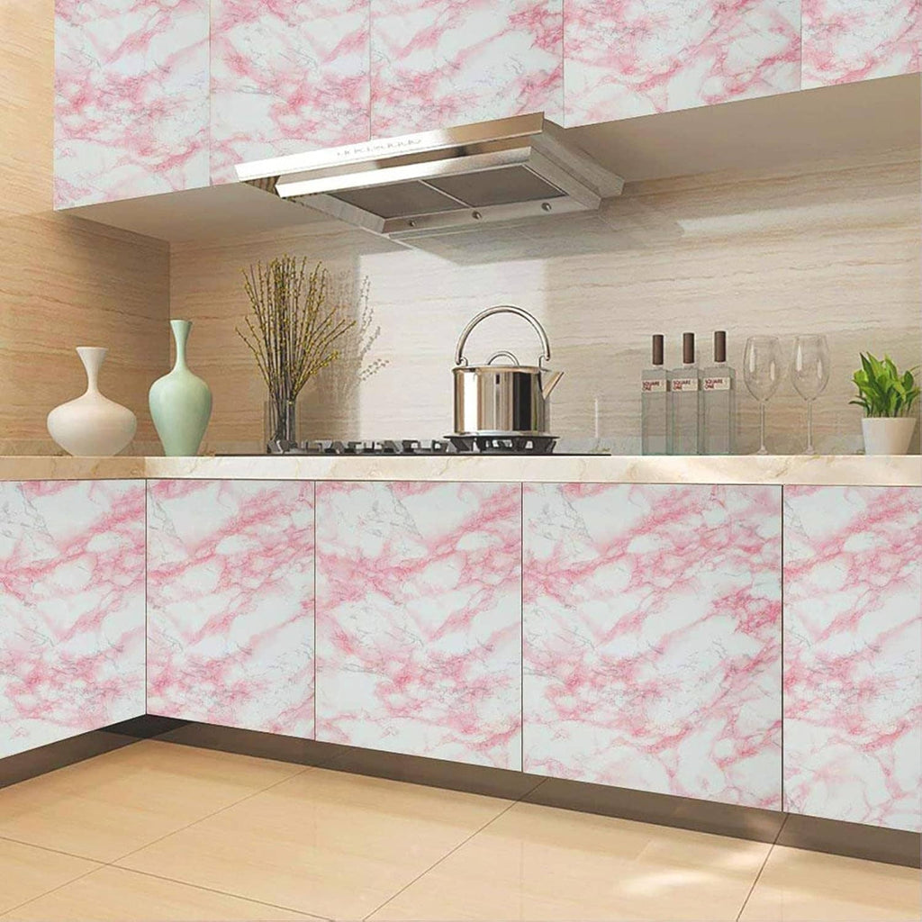 Pink marble peel-and-stick cabinet fronts and backsplash film in a kitchen corner