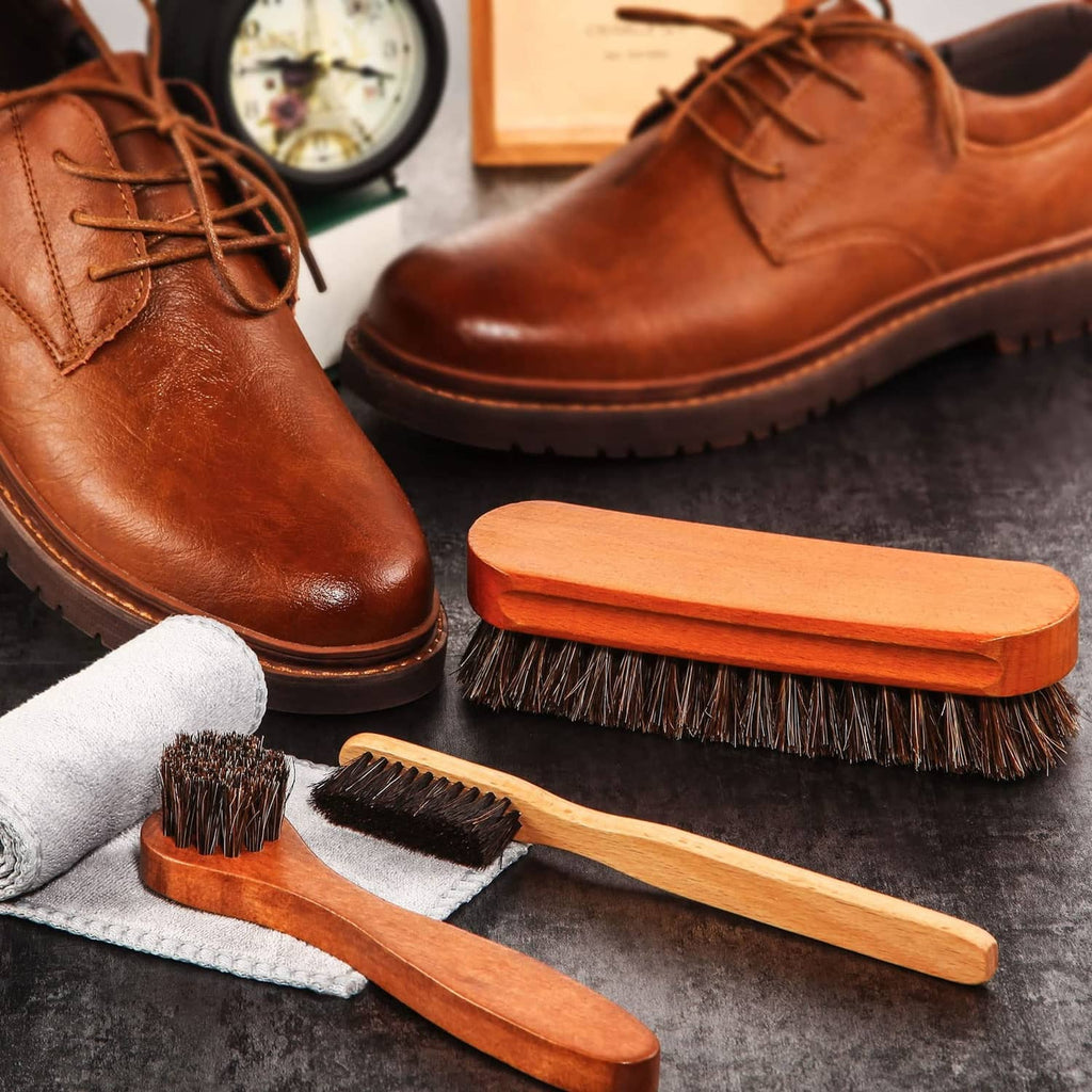 Wood-handled horsehair shoe brushes and polishing cloth, arranged with a pair of shoes