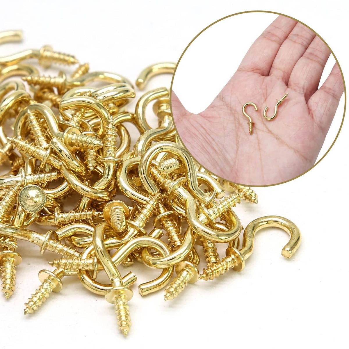 Gold ceiling cup hooks with screws, close-up with hand holding several