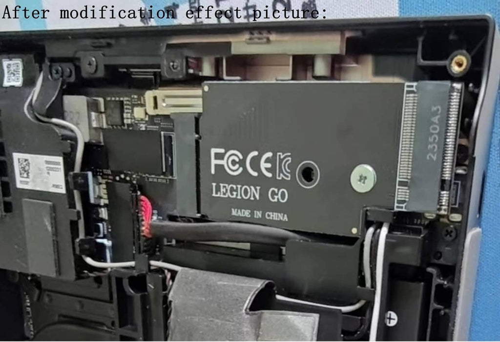 Black adapter module inside handheld with ribbon connector and mounting plate