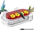 Window hummingbird feeder with red tray and yellow flower feeding ports, clear base