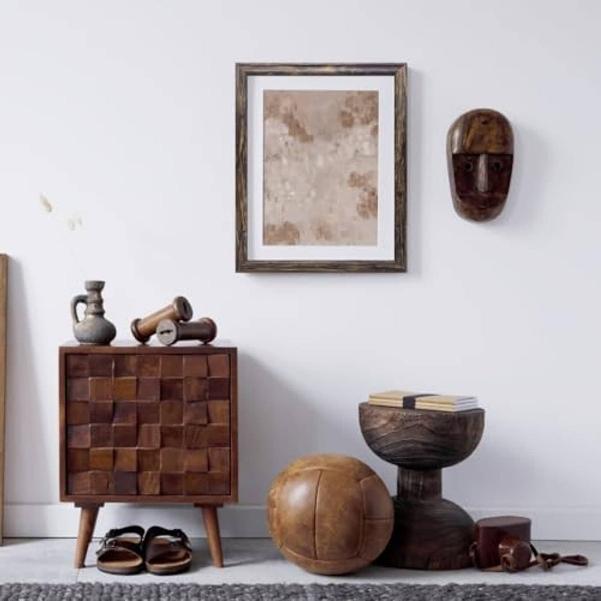 Square rustic brown photo frame mounted on a wall, centered above decor