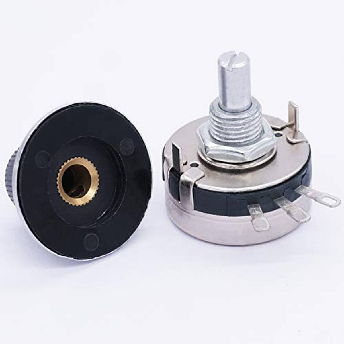 Rotary potentiometer rear view with black bushing, gold insert, and silver pins