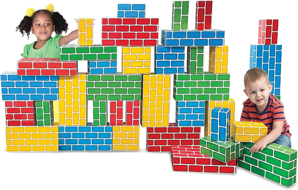 Colorful cardboard building blocks with kids standing near large brick wall structures