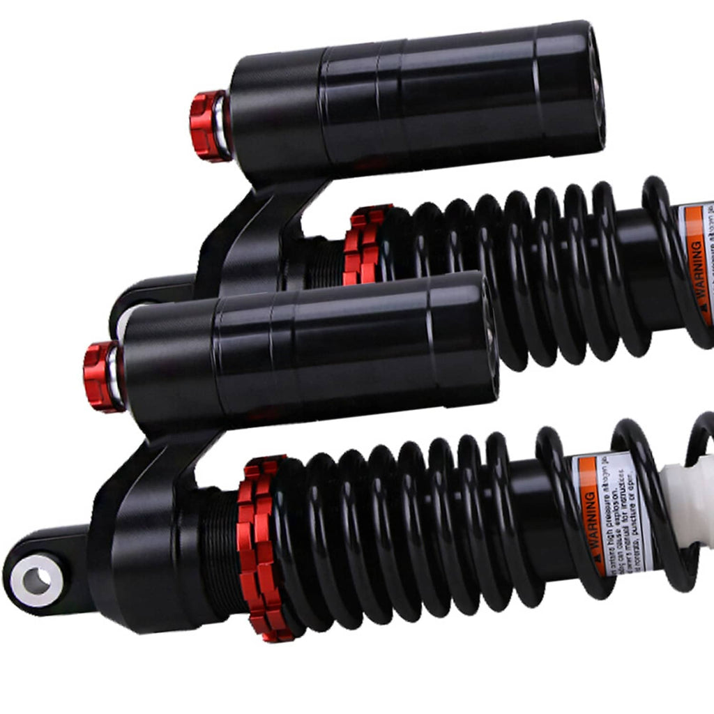 Closeup of front air shock absorbers with black bodies, coil springs, and red caps