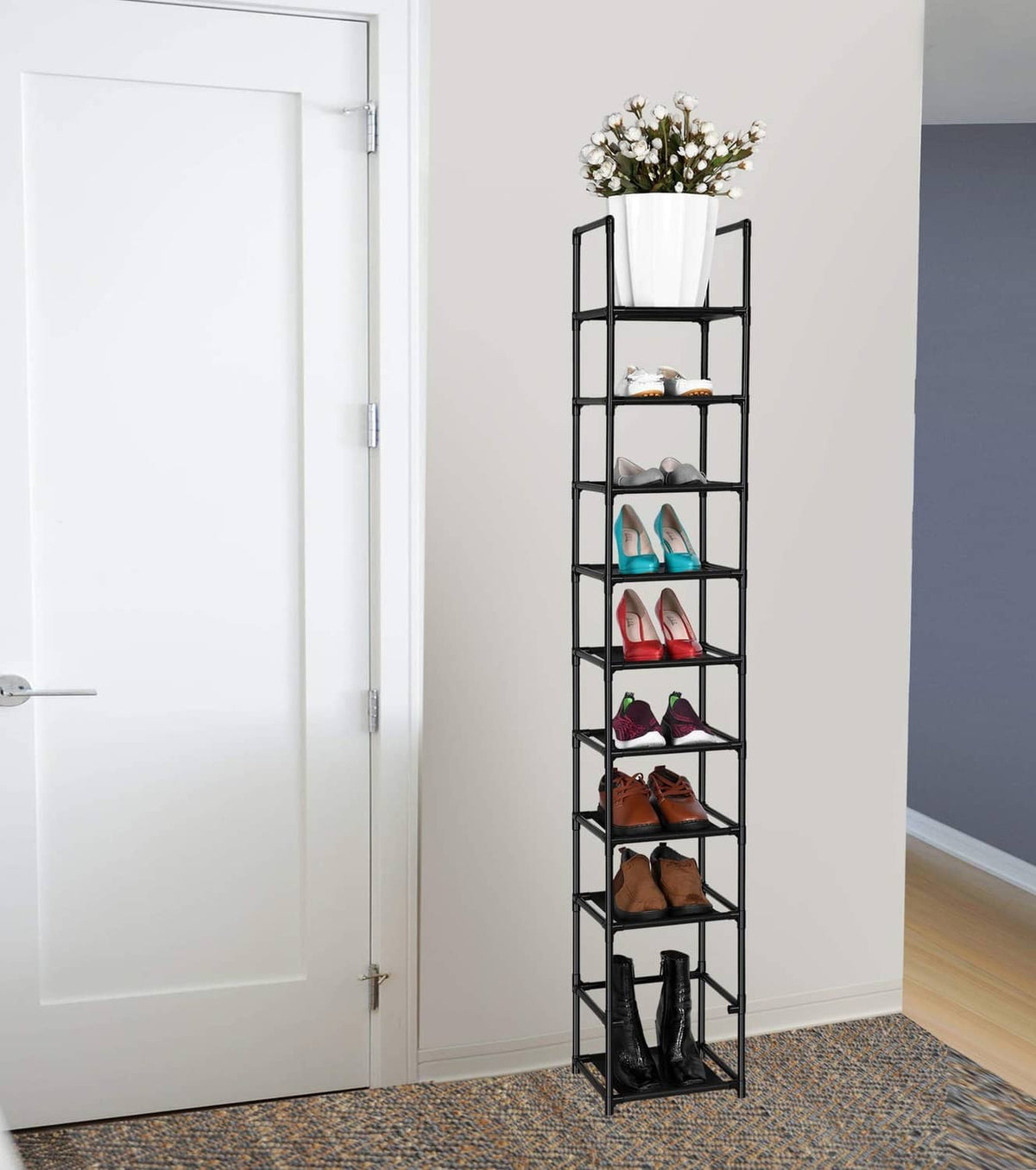 Black 10-tier vertical shoe rack near wall with open shelves and assorted shoes