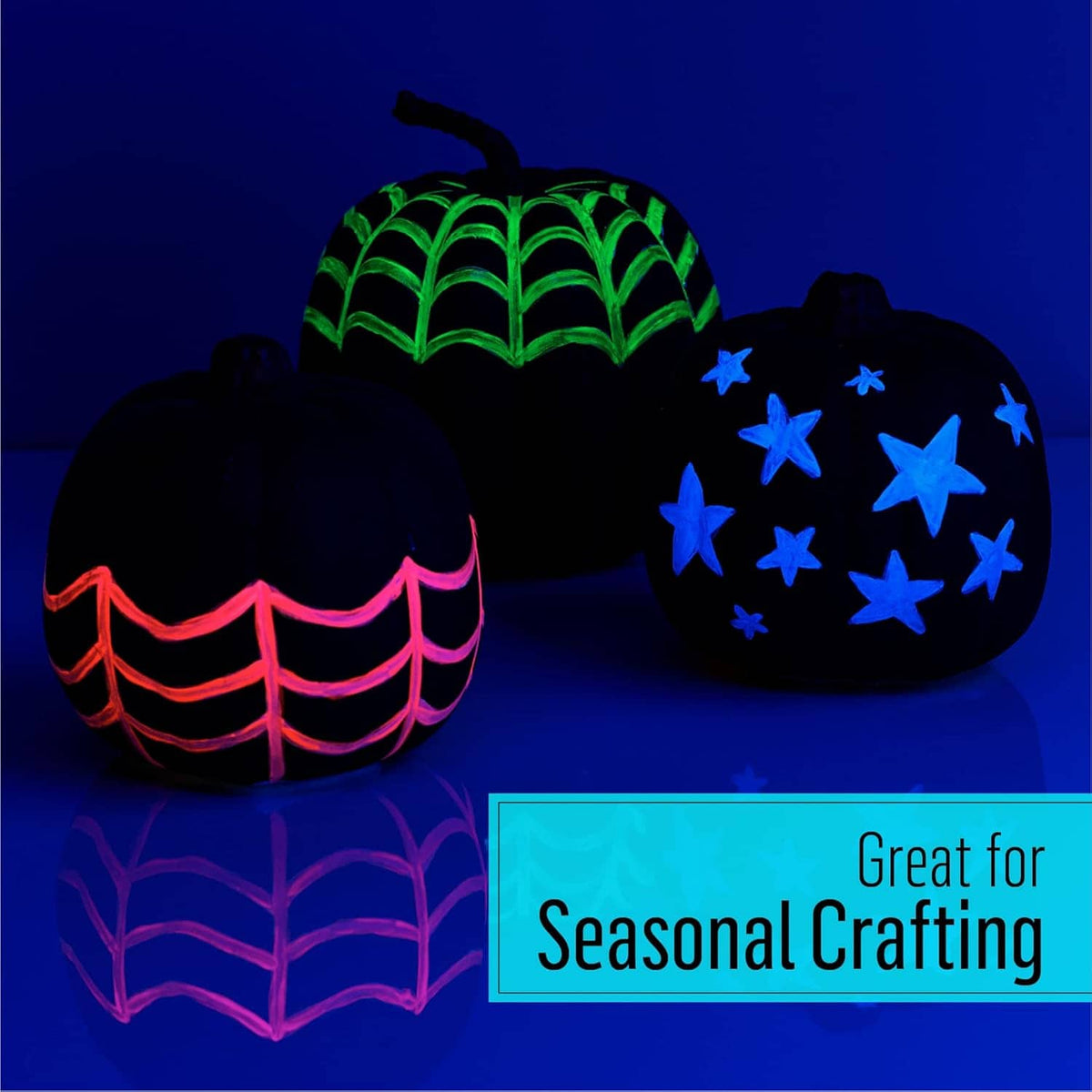 Glow-in-the-dark paint illuminating craft ornaments: green-lit tree and star-decorated items.