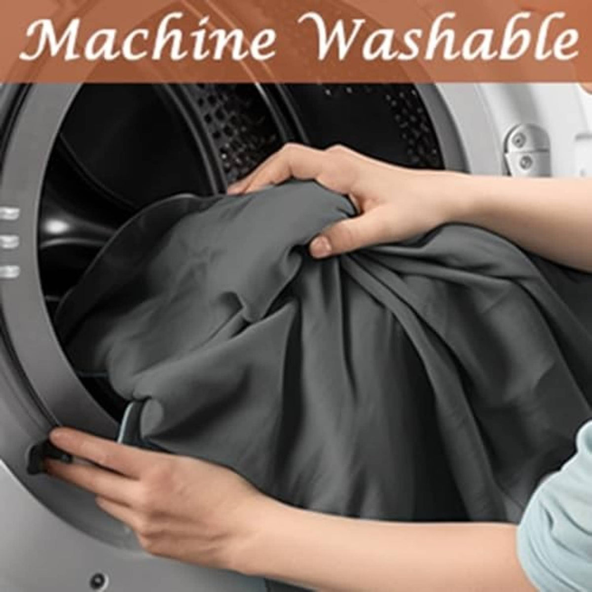 Dark gray microfiber massage table sheet being placed into a washing machine
