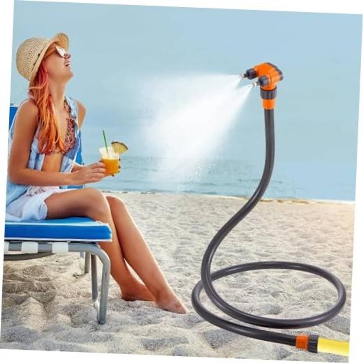 Standing patio misting hose with orange 360° nozzle, spraying fine water mist from loop