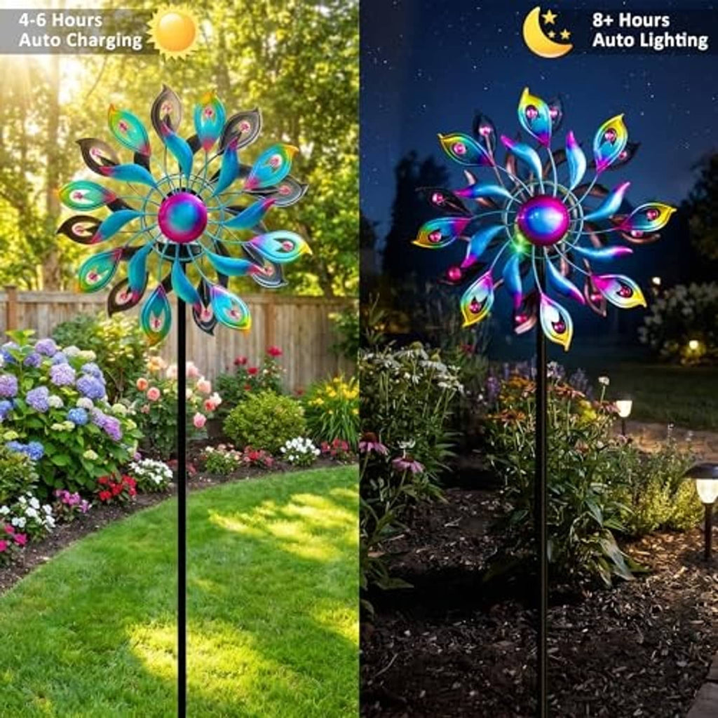 Glowing peacock wind spinner in outdoor garden at night with multicolor LED feather blades