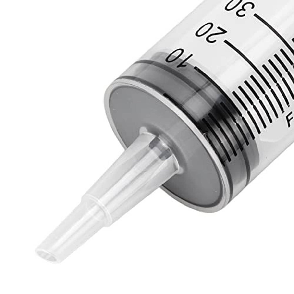 Close-up of hydraulic bleeder syringe with black measurement band and clear outlet tube