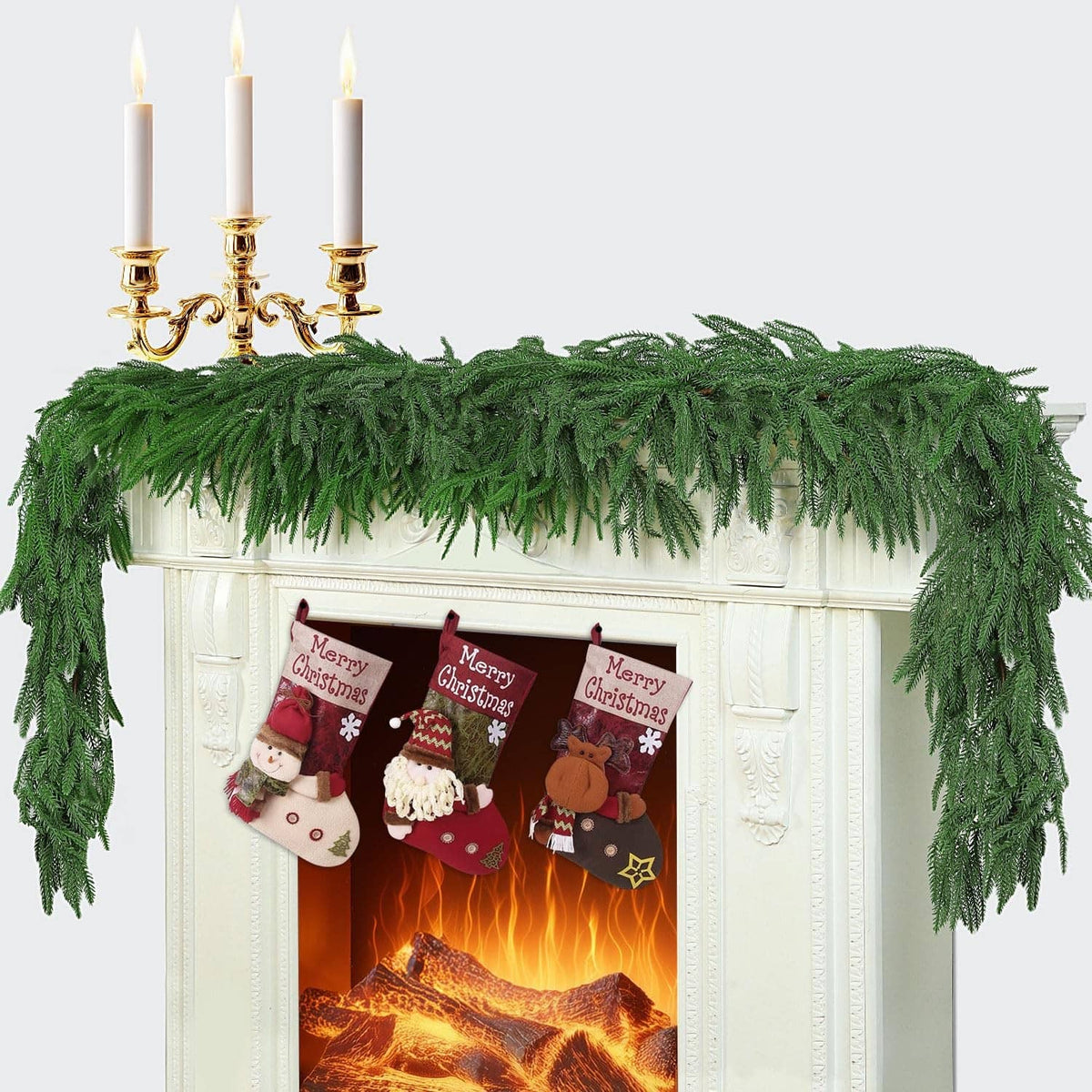 Green artificial pine garland with dense layered needle tips, draped in a straight row.