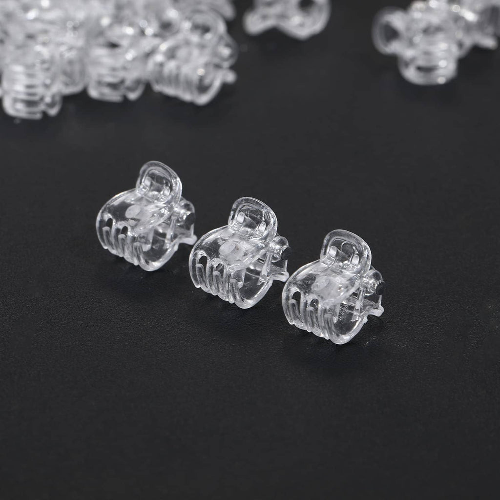 Three clear mini claw hair clips with open claw prongs
