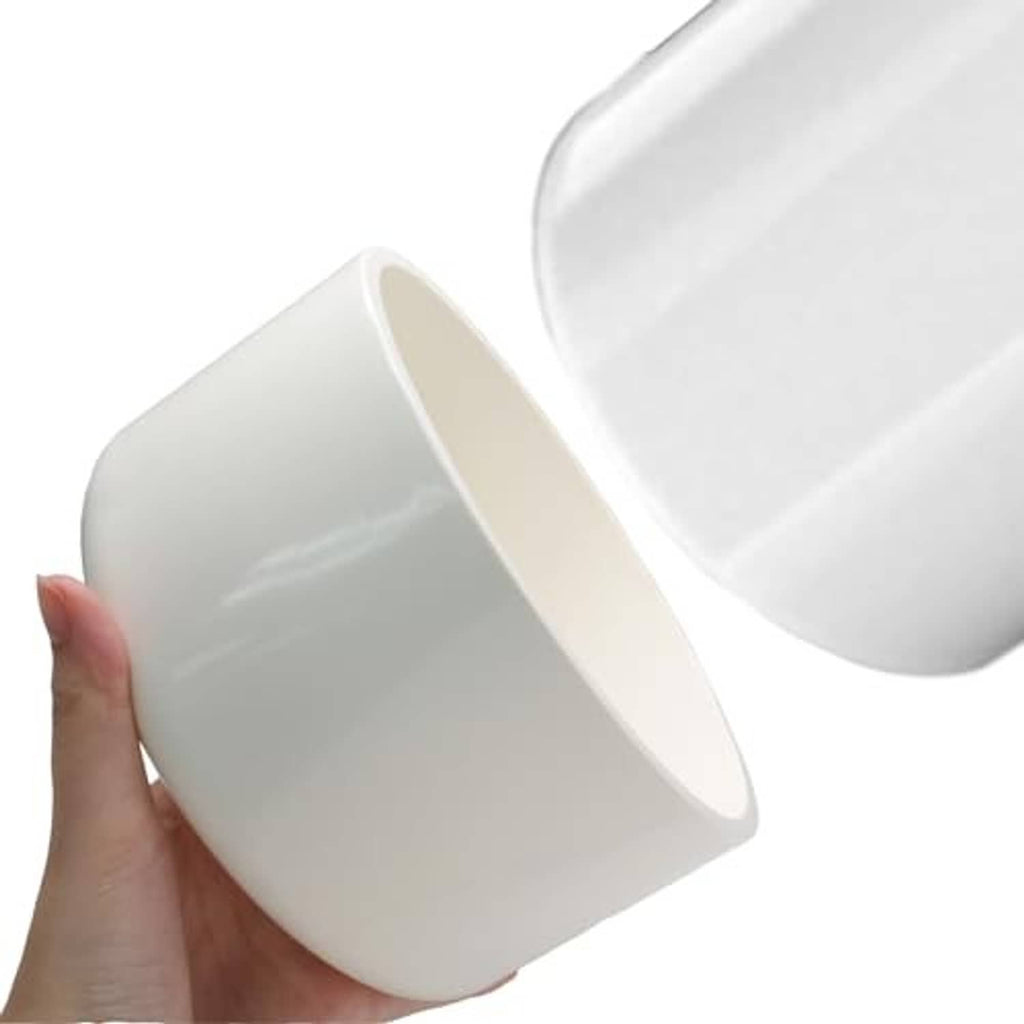White PVC pipe end cap fitting held in hand, showing round interior opening