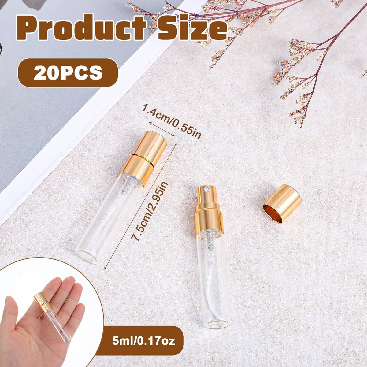 Mini clear glass perfume atomizer bottle with gold cap, shown in hand with others
