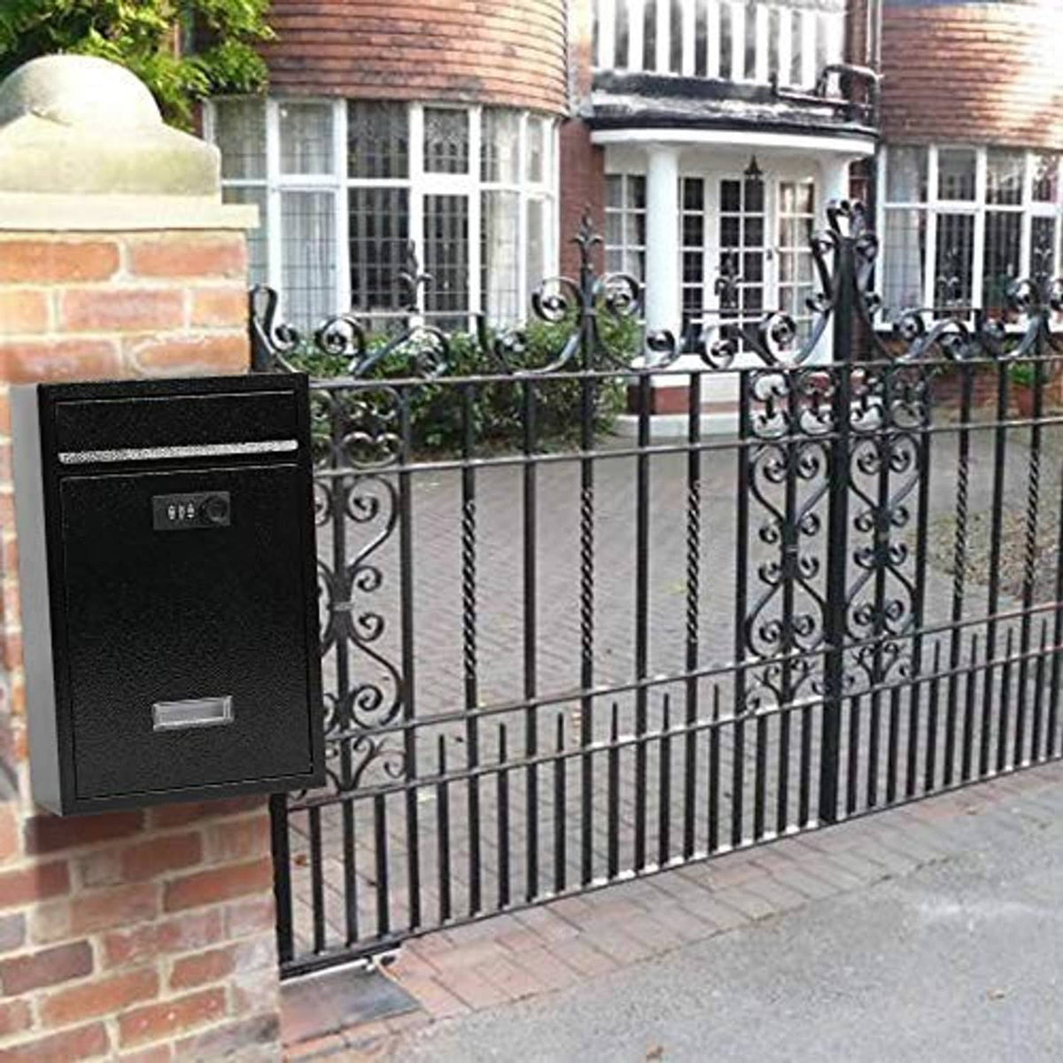 Black wall-mount mailbox with combination lock installed on wrought-iron fence