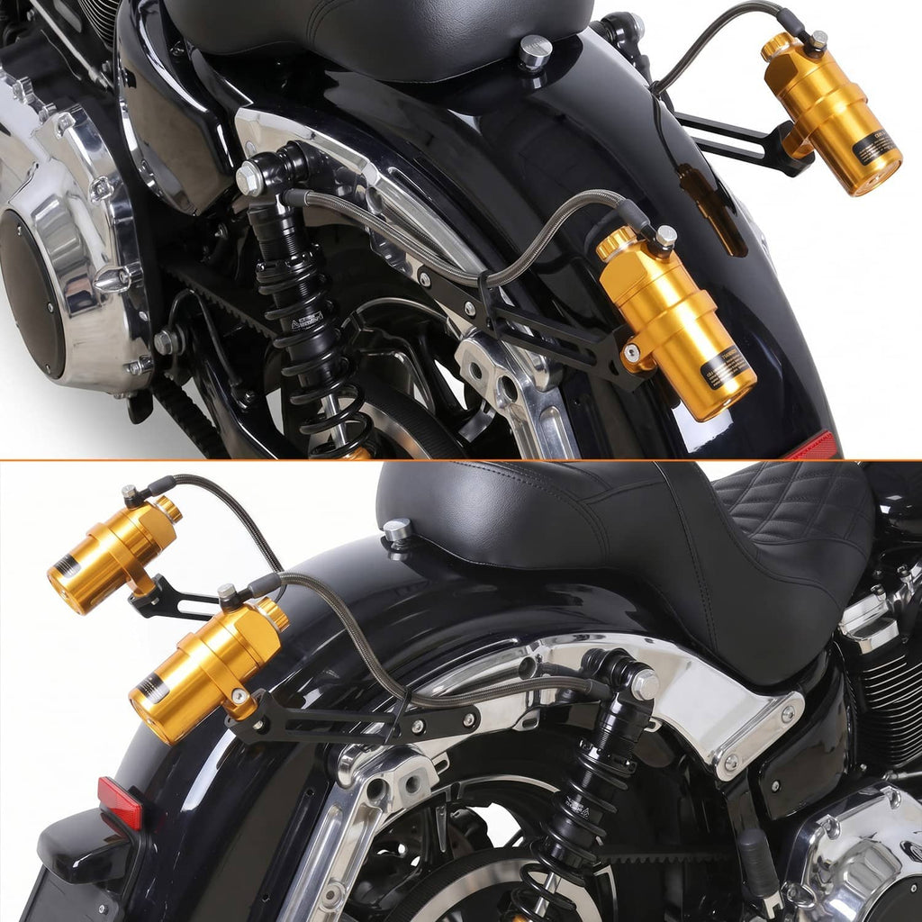 Two gold reservoir shocks with black coils installed on a motorcycle frame