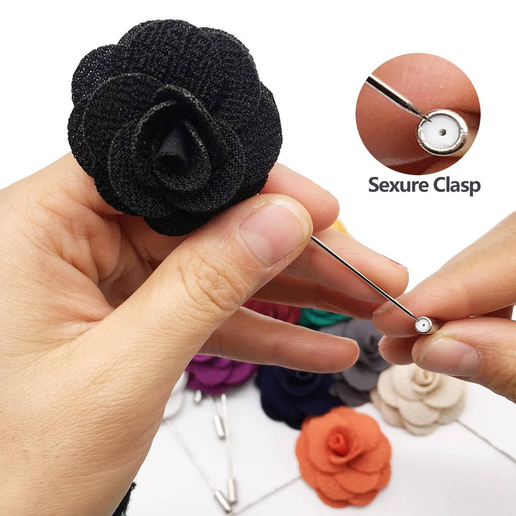 Black fabric rose lapel pin held in hand with metal pin back