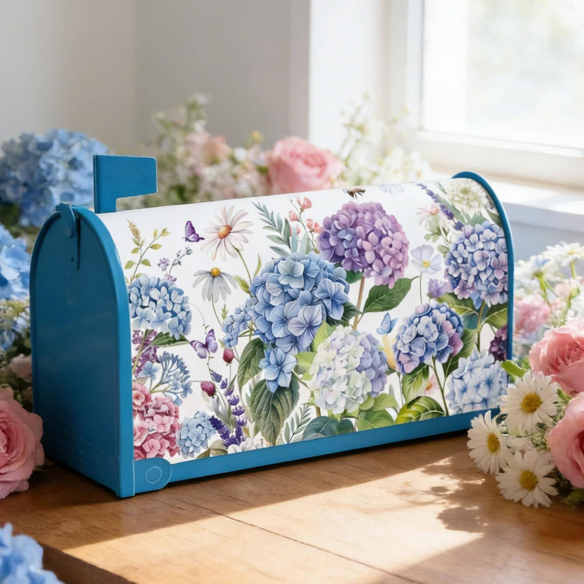 Floral hydrangea mailbox cover with blue frame on indoor tabletop display