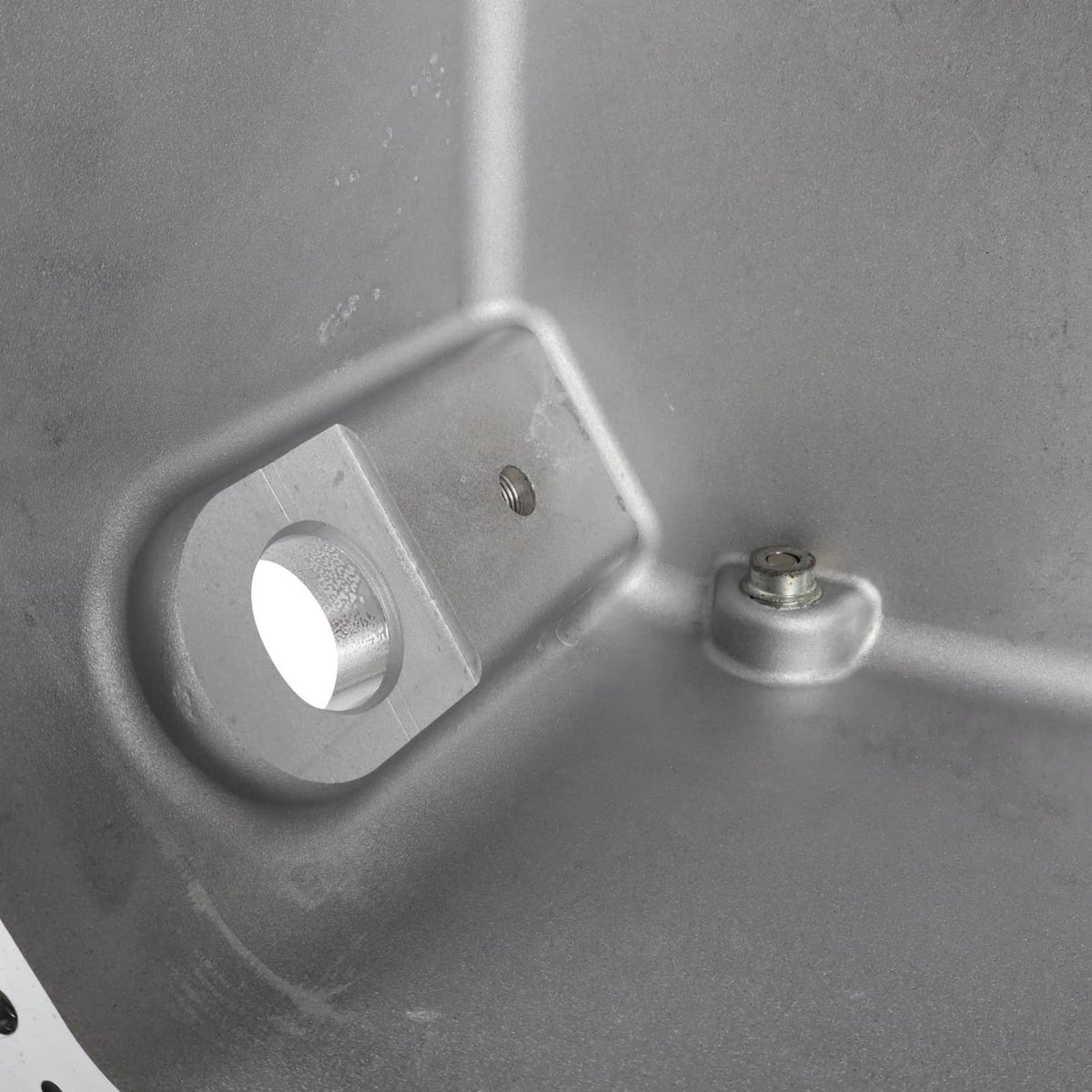 Oil pan interior with circular mounting hole and small pin boss