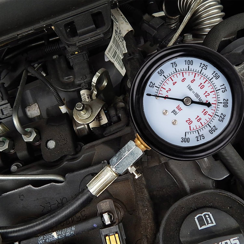 Compression tester gauge connected to a small engine in an engine compartment