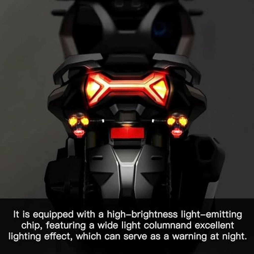 Motorcycle front with glowing skull-style LED warning lights in red and amber