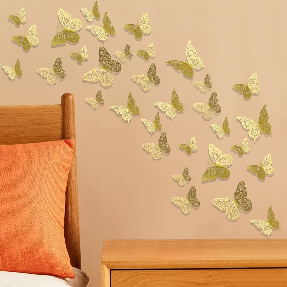 Gold 3D butterfly wall stickers scattered on a wall near a wooden bed headboard