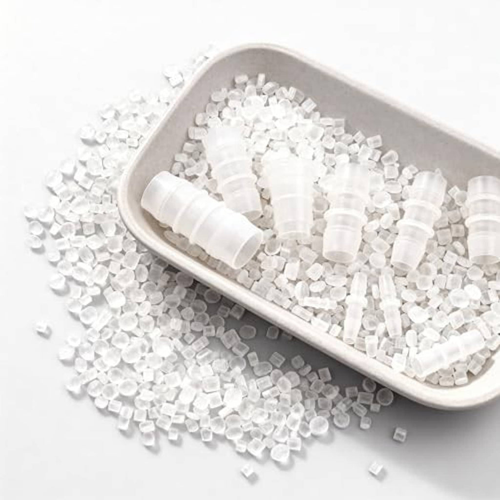 Assorted white plastic hose barbed splicer coupler fittings in a tray
