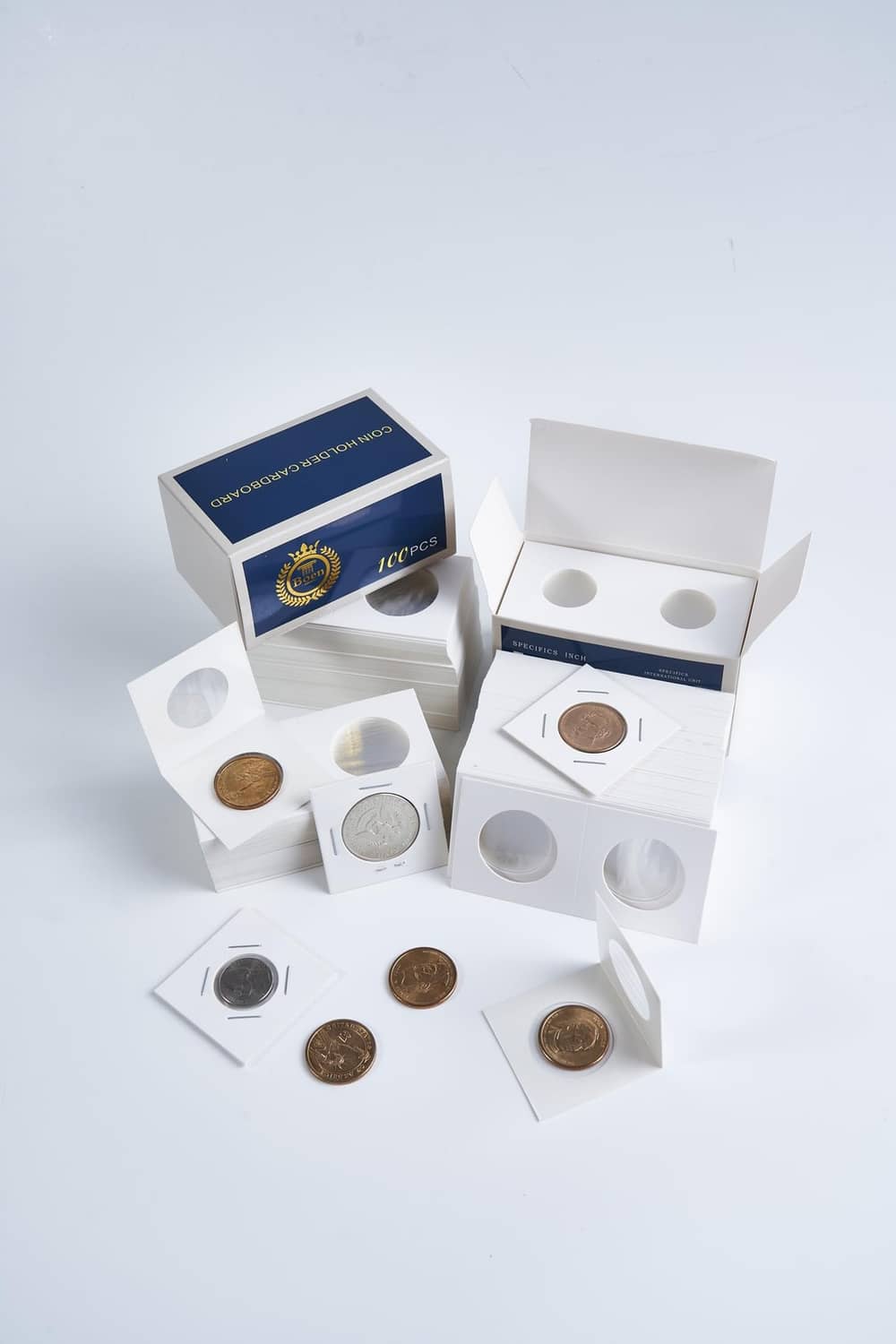 Assorted coin flips with cardboard sleeves, oval openings, and mixed coins