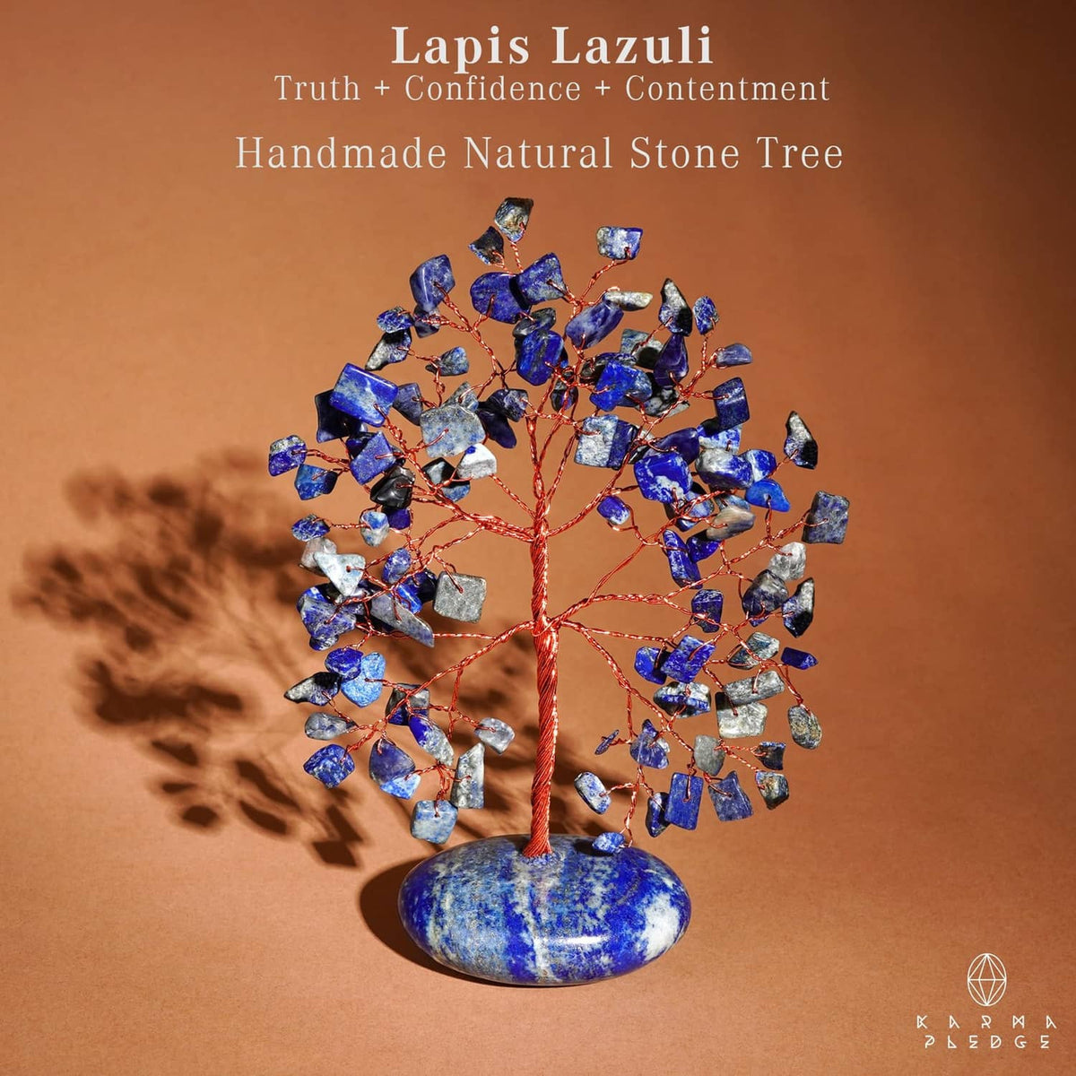 Handmade lapis lazuli stone tree with blue chips and red wire on oval palm stone base