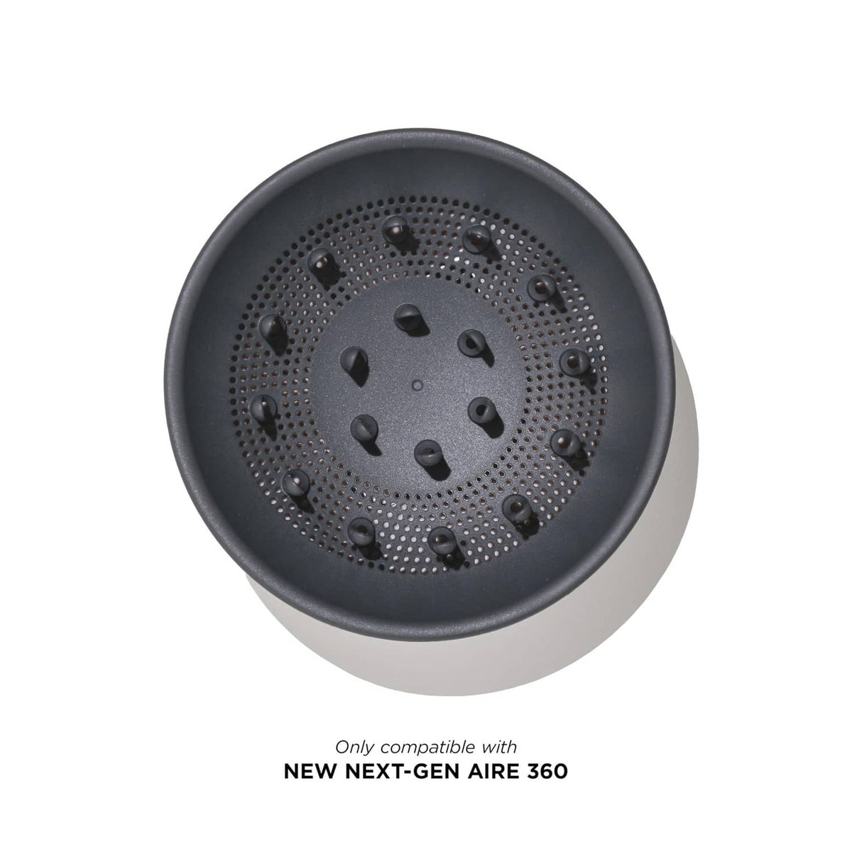 Round dark gray diffuser plate with perforations and central vent holes