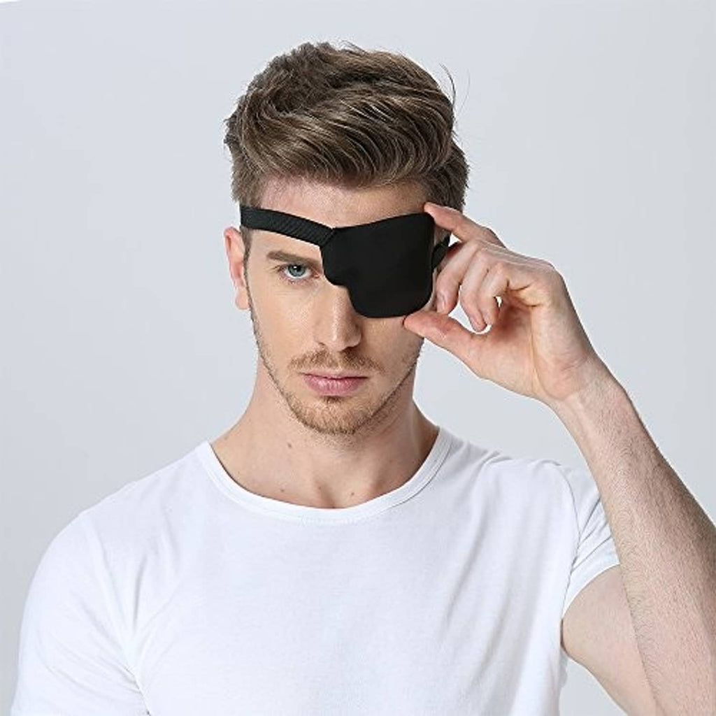 Black 3D contoured left eye patch on man, hand adjusting elastic strap