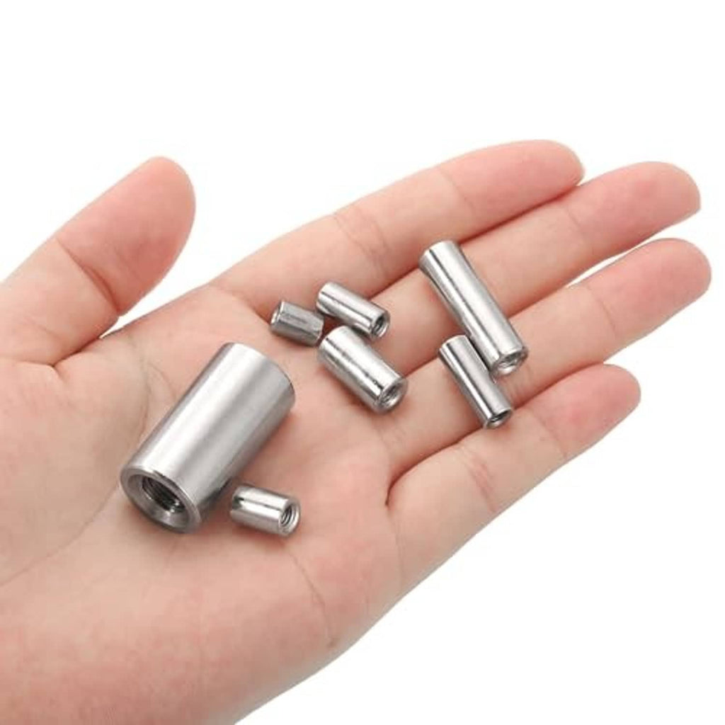 Stainless steel round coupling nuts held in a hand, showing internal threads