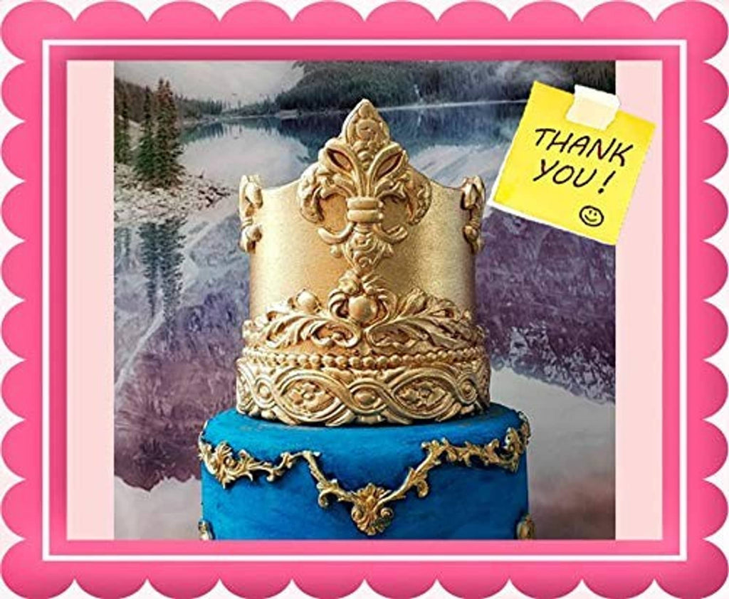 Gold glitter crown cake topper with ornate metallic finish on a cake