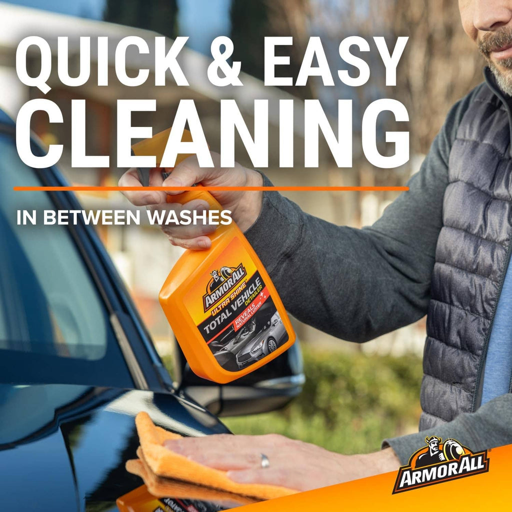 Car exterior quick cleaning: man holding orange detailer bottle and cleaning cloth