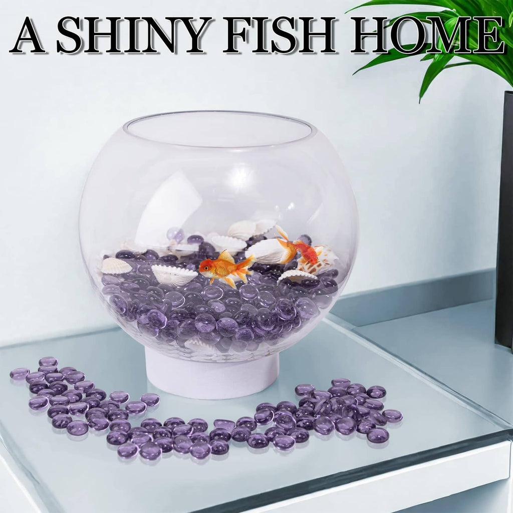 Purple glass gems scattered as aquarium decoration around a clear fish bowl
