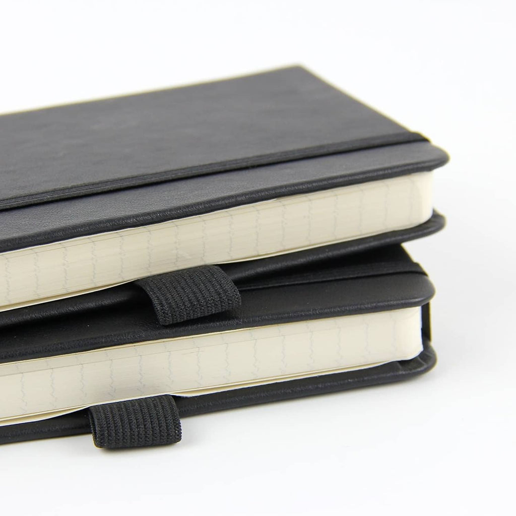 Stack of Newestor pocket notebooks with dark covers, elastic strap, and light ruled pages