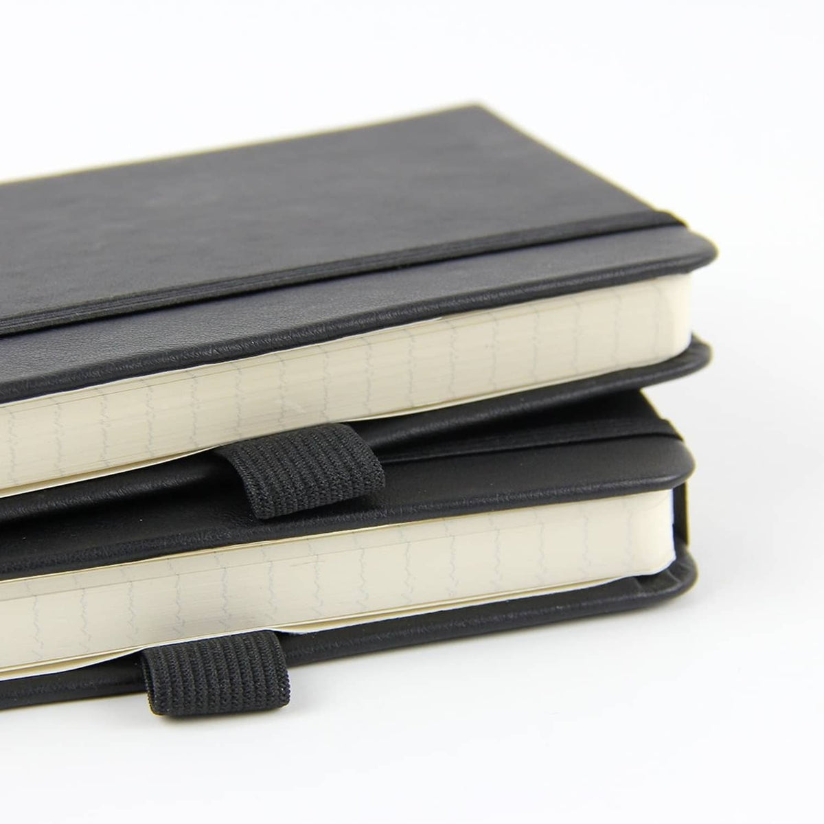 Stack of Newestor pocket notebooks with dark covers, elastic strap, and light ruled pages