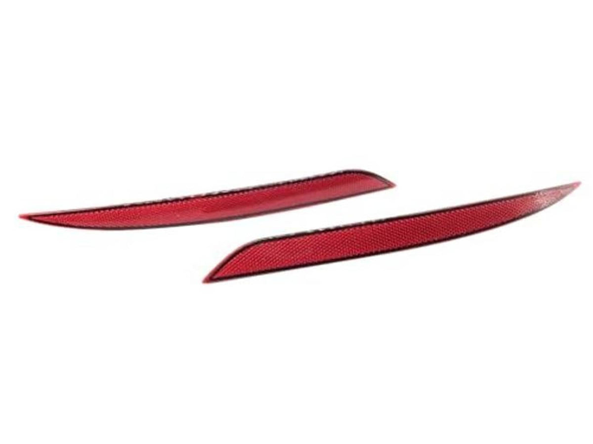 Two red reflector lens inserts with textured pattern for rear bumper trim